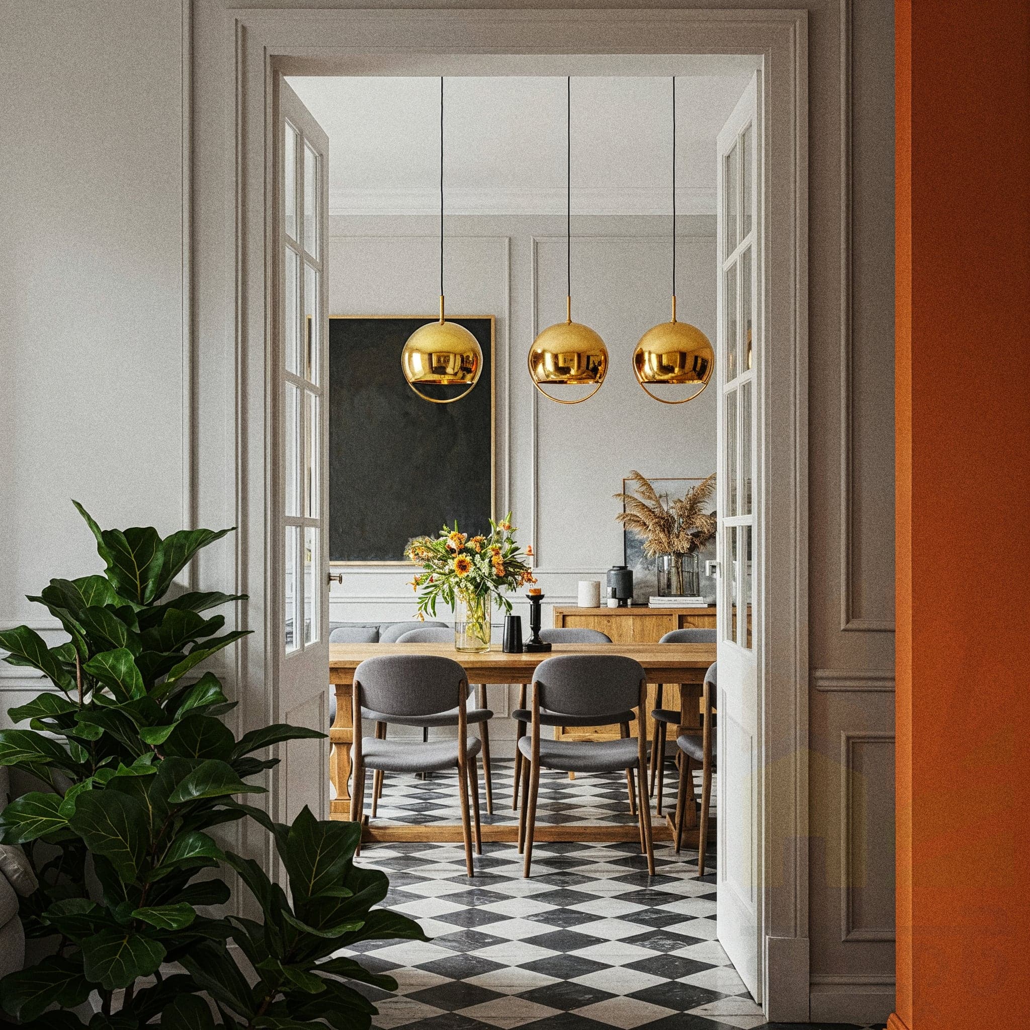 A functional and inviting dining room with a Rustic Modern design, featuring a long wooden dining table surrounded by matching wooden chairs with neutral cushions. The room includes a rustic chandelier with warm Edison bulbs, a wooden sideboard with a potted plant and decorative bowls, and a woven beige rug. Large windows with sheer curtains allow natural light to highlight the dark wooden floor and light beige walls, creating a cozy yet contemporary dining atmosphere.